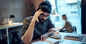 Male student reading book